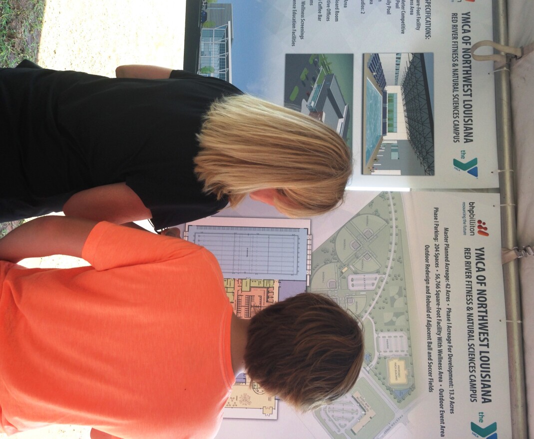 Groundbreaking ceremony attendees check out the blueprint for the YMCA Red River Fitness Facility, a 57,000-square foot building under construction in Shreveport.